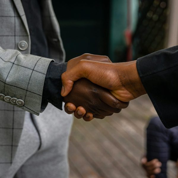 Close-up of two professionals shaking hands, symbolizing success and partnership.